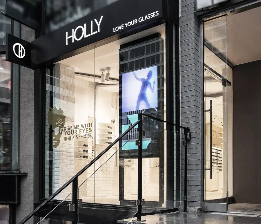 Holly Eyewear storefront in Toronto, a NishMark8ing Local Visibility client, with its black awning and glass entrance